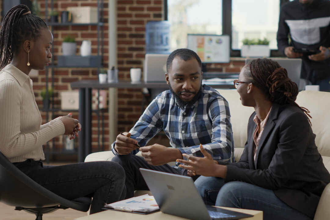 Team of business people collaborating to plan financial strategy Team of business people collaborating to plan financial strategy, doing teamwork to create sales report on laptop. Office employees working on project strategy to analyze career growth.